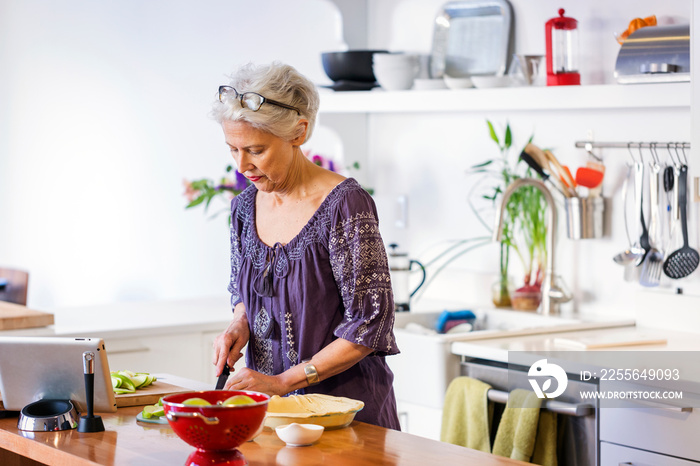 Two women cooking together in kitchen