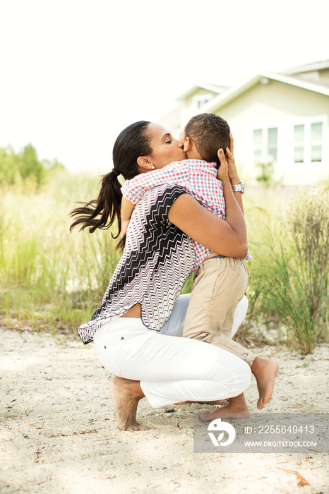 Woman kissing her son (2-3) on cheek