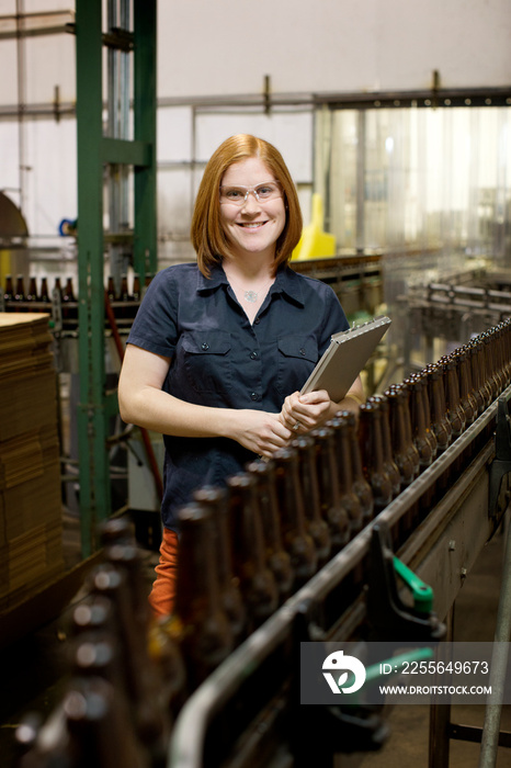 Two brewery workers with beer bottles