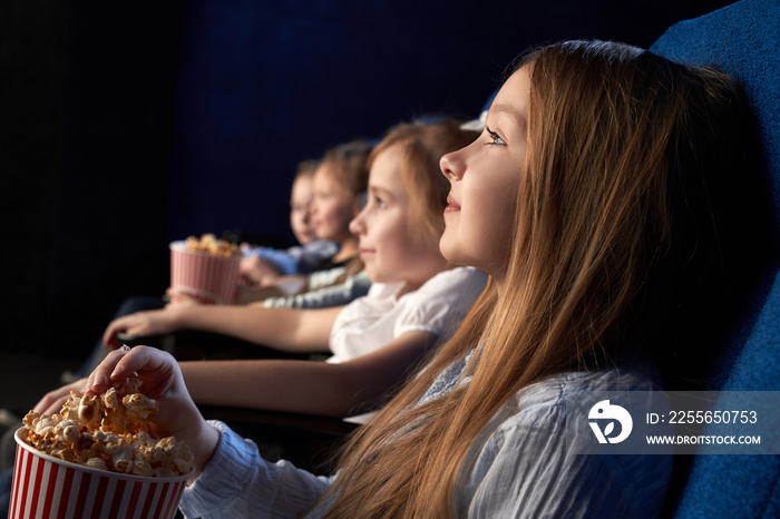 Children watching movie in cinema theatre.