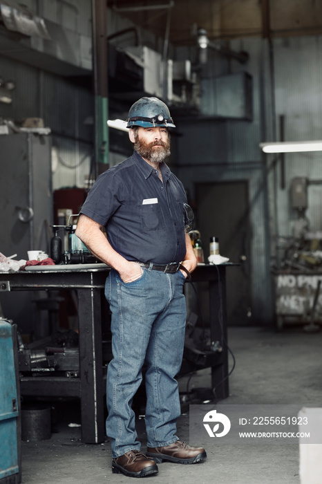 Portrait of man standing in factory