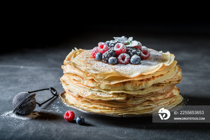 Stack of pancakes with berries and mint. Pancakes for breakfast