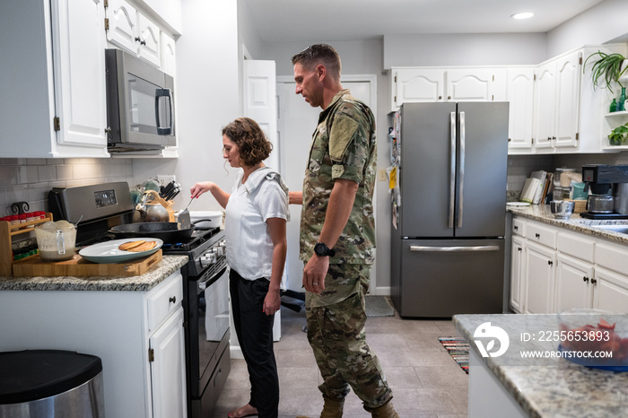 Air Force service member has breakfast with his family before leaving for work.