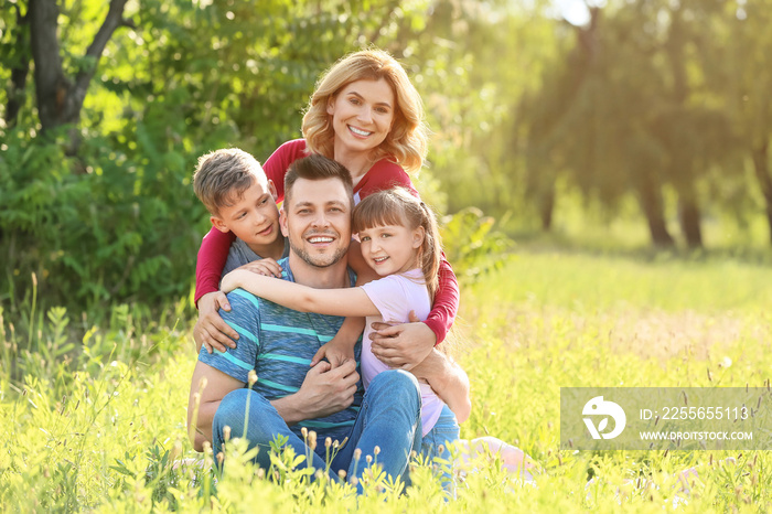 Happy family resting in park