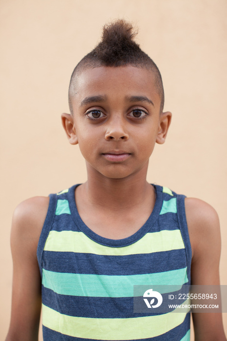 Portrait of boy with mohawk hairstyle, front view