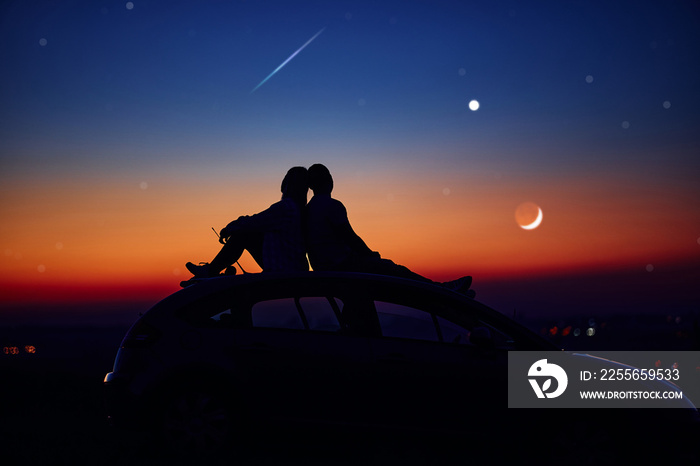 Couple stargazing together with a astronomical telescope.