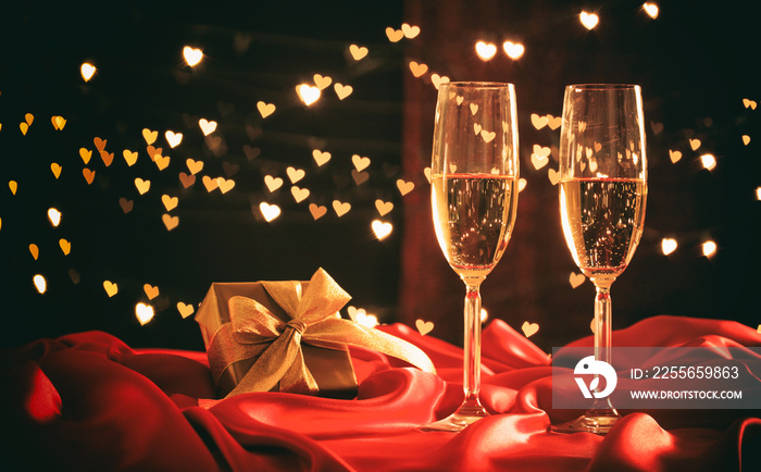Champagne glasses on hearts bokeh background