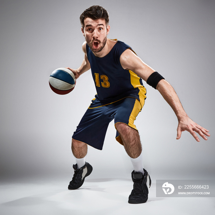 Full length portrait of a basketball player with ball