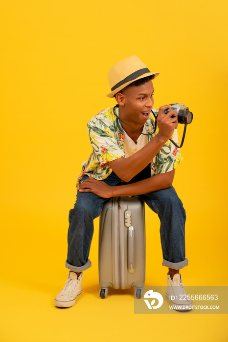 Young tourist man taking photos with camera.