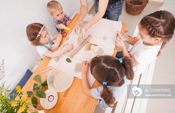 Happy children are engaged with modeling clay