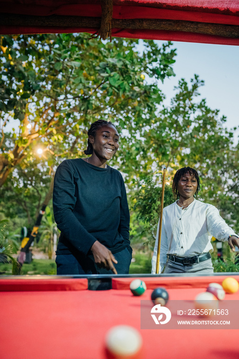 Queer masculine women playing pool