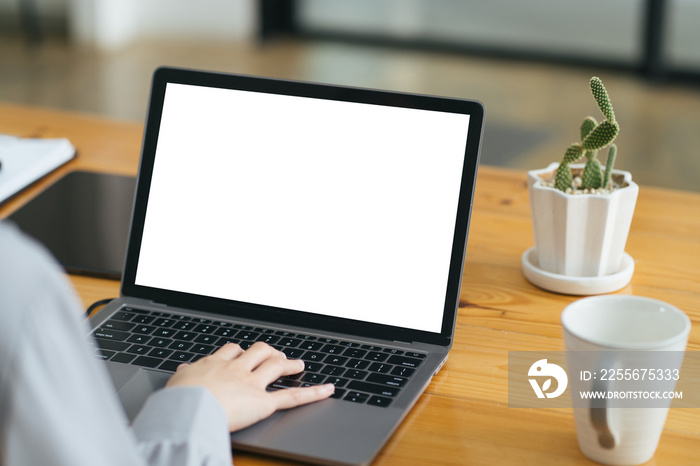 Close up image of a female assistant working on laptop computer at her workspace. laptop blank scree