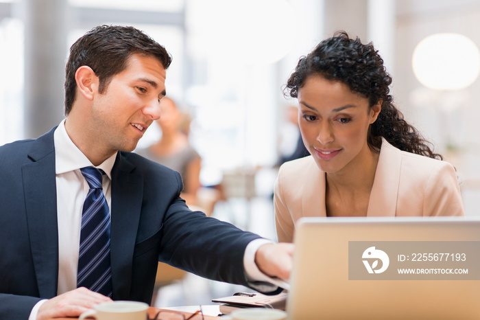 Corporate business people talking at laptop