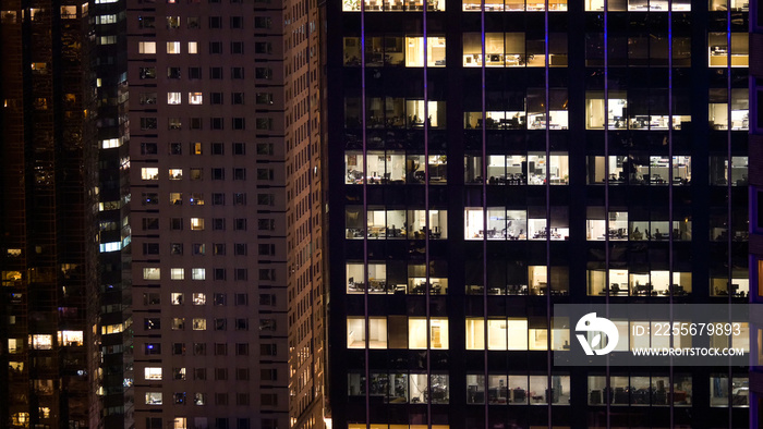 CLOSE UP: Empty offices in corporate skyscrapers are left lit up into the night.