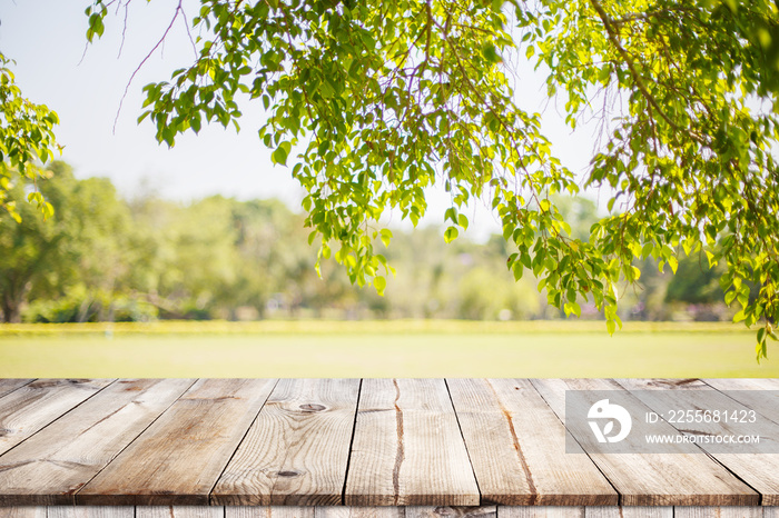 Empty wooden table with garden bokeh for a catering or food background with a country outdoor theme,