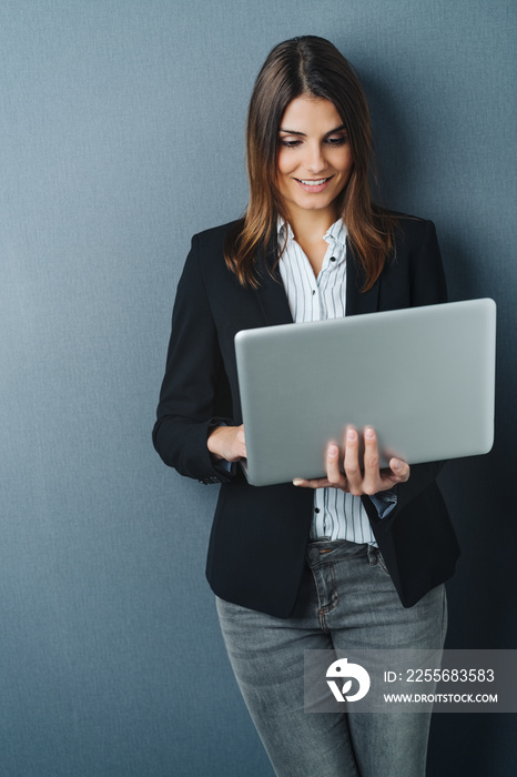 Attractive businesswoman using a handheld laptop