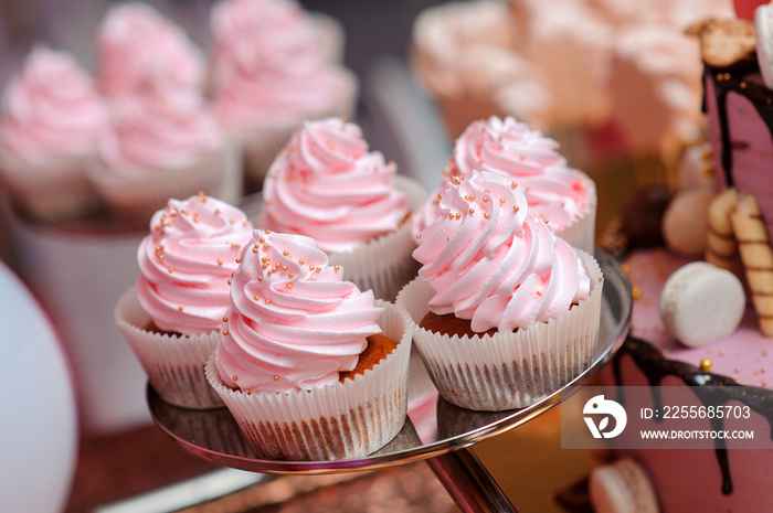 Pink cupcakes on the plate on the candy table