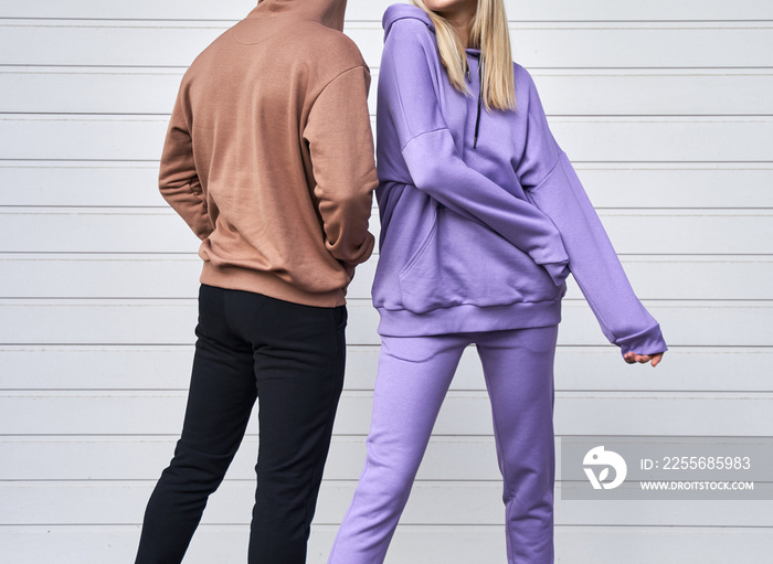 Two persons is standing in casual streetwear without logo. Design template of sport clothing line