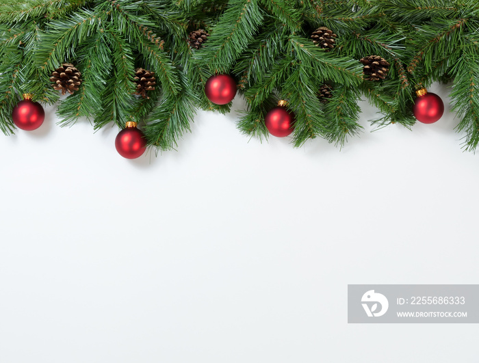 Christmas red ornaments hanging in fir tree branches