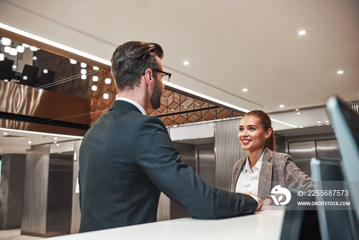 Couple on a business trip doing check-in at the hotel