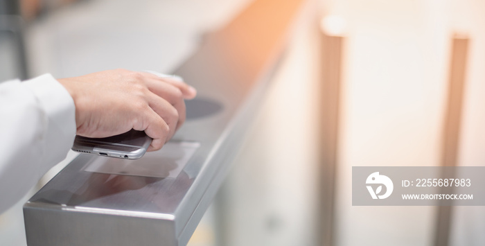 The female hand contactless pays for the public transport in the subway,