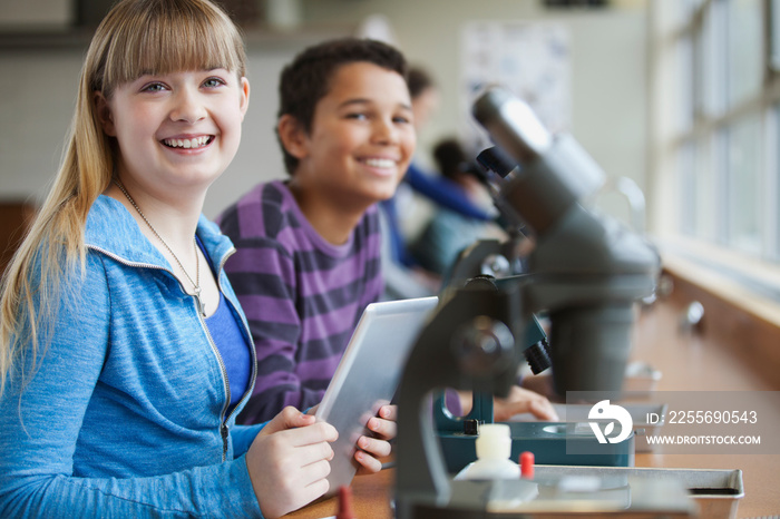 Middle school students using microscopes