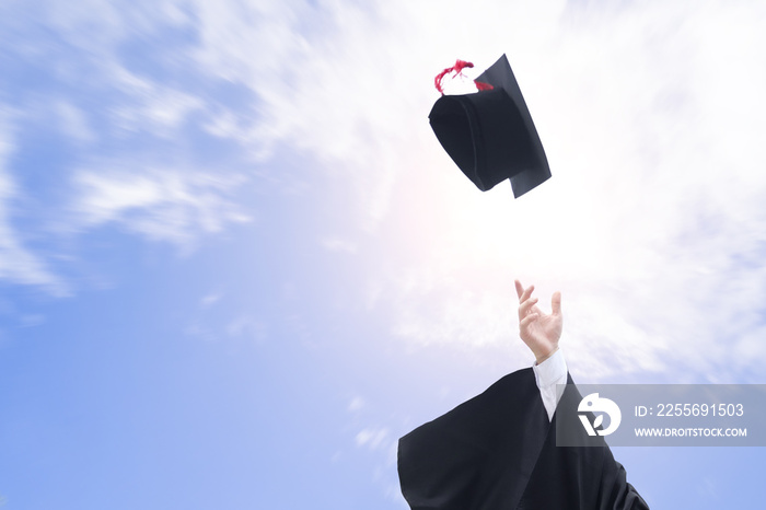 Graduates throwing graduation hats in the air