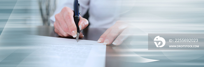 Businesswoman signing a document; panoramic banner