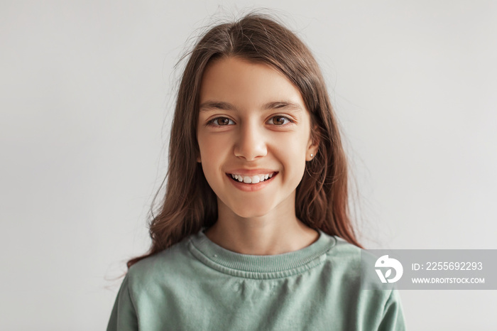 Headshot Of Happy Girl Smiling Looking At Camera, Gray Background