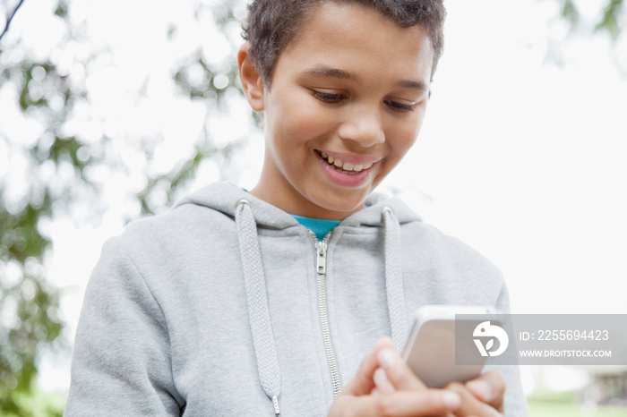 Portrait of African American youth using smart phone