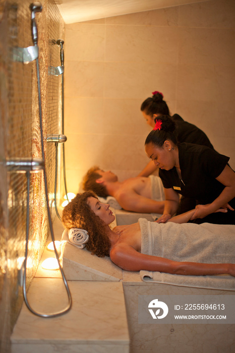 Young couple having a massage in spa