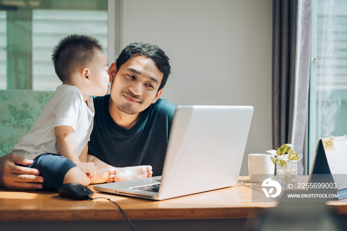 Kissing moment, Father and little son happy family with laptop computer on workplace at office home 