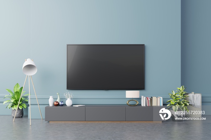 现代客厅橱柜上的电视，背景为深蓝色。