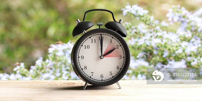 European daylight saving time. Alarm clock on wooden desk, blur spring nature background. 3d illustr