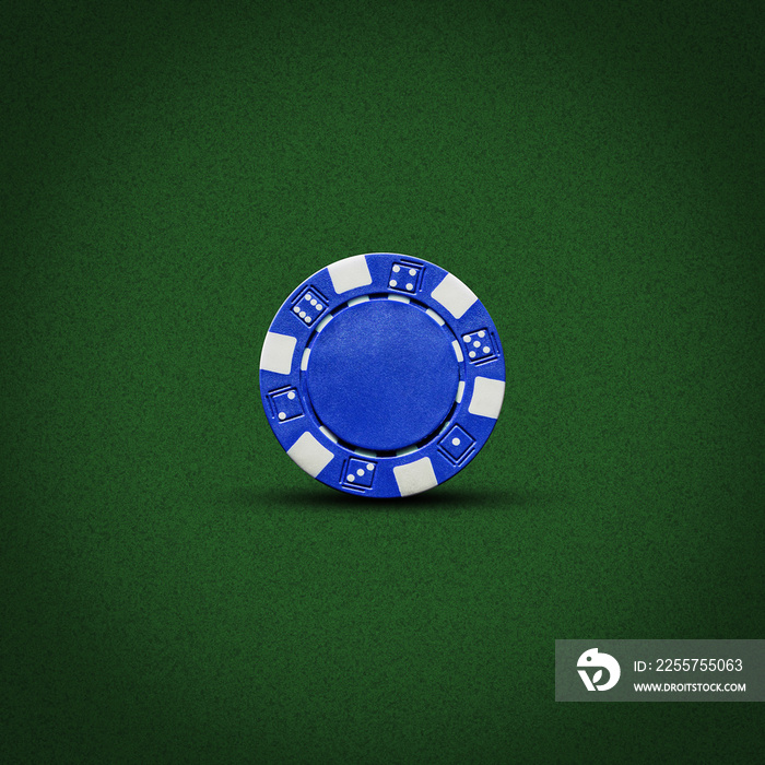 Blue poker chip, on a dark green background. Gambling.