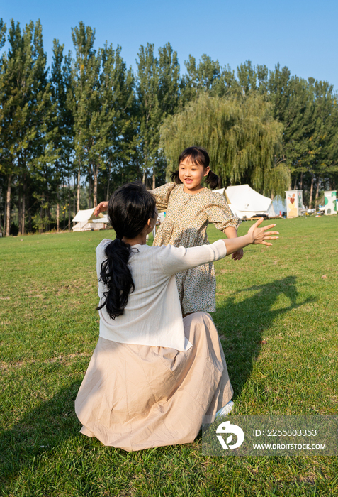 妈妈和女儿在草地上做游戏