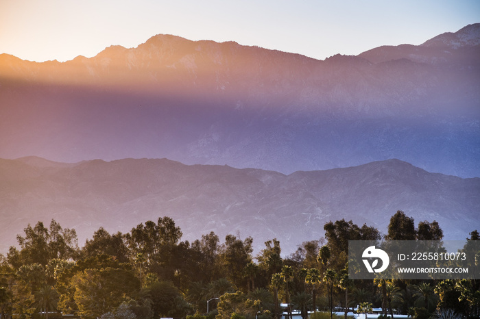 Sunset Landscape in Coachella Valley, with sun rays shining on the rocky ridges of the San Jacinto mountains, Palm Desert, California