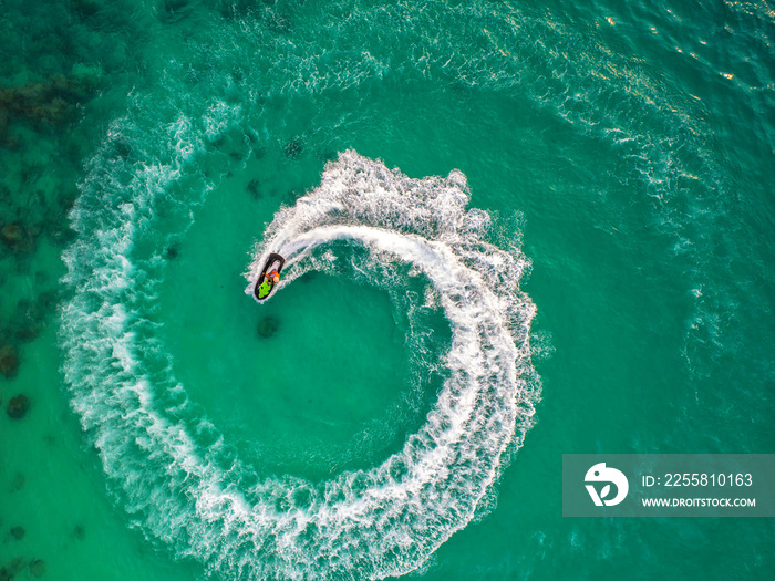 People are playing jet ski at sea during the holidays. And beautiful nature backdrop.