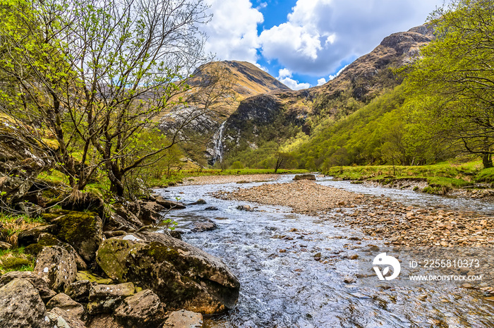 A view up the River Nevis towards the Steall Waterfall in Glen Nevis, Scotland on a summers day