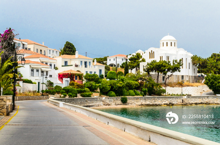 Beautiful View of Spetses Town with Traditional Neoclassic Buildings and White Cathedral Church of Saint Nicolas by the Sea. Picturesque Bay in Saronic Gulf, Spetses Island, Greece