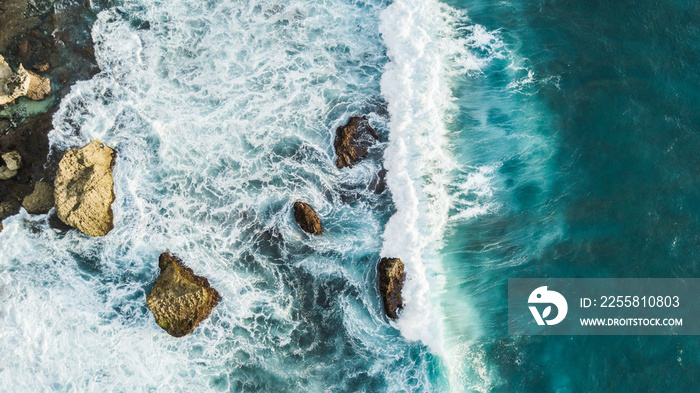 Aerial view of crashing waves on rocks. View from above, drone photo, beautiful nature background