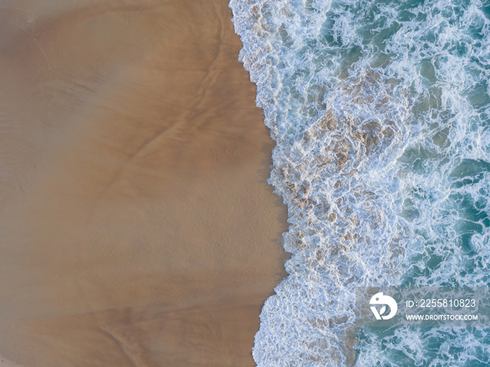 Aerial view of drone. Top view beach sea sand and surf. In summer day. Seawater on sandy beach. Nature background and travel concept.