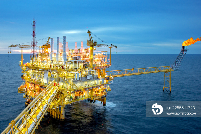 Large Offshore oil rig drilling platform at sunset and beautiful sky in the gulf of Thailand