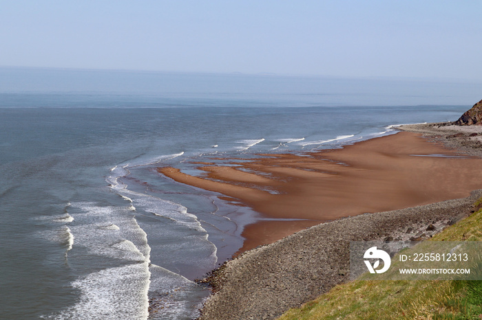 Waves crashing on the small beach at Hurlstone Point near Bossington in Somerset, England.