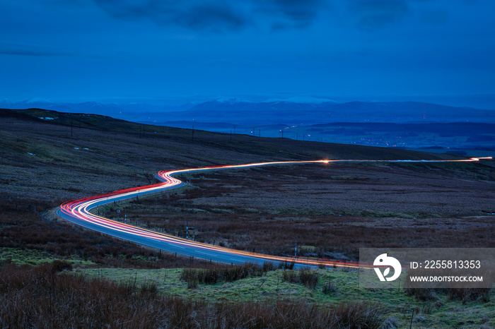 Car Light Trails on Hartside Pass / Hartside Pass in the North Peninnes, Cumbria with Eden Valley and the snow capped mountains of the Lake District beyond