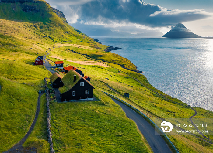 Majestic summer view from flying drone of Velbastadur village with typical turf-top houses. Extraordinary morning scene of Streymoy island, Faroe, Denmark, Europe. Traveling concept background..