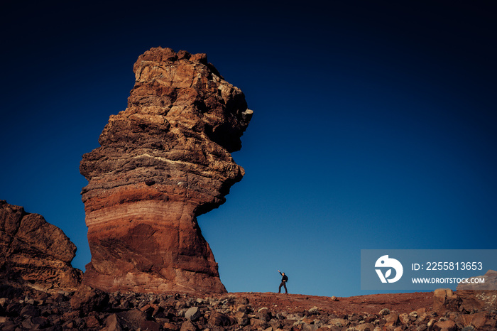 Big rock formation of Los Roques de Garcia compare with small human, Teide National Park, Tenerife, Spain. Winners concept.