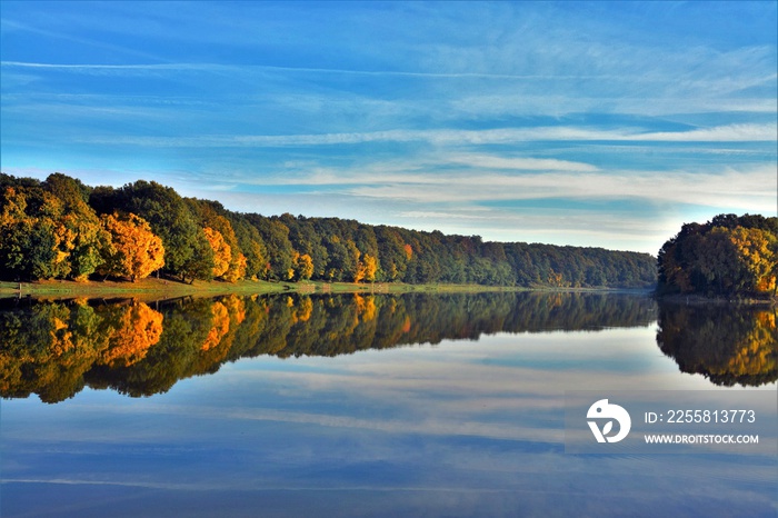 reflection of the yellowed forest in the water of the lake