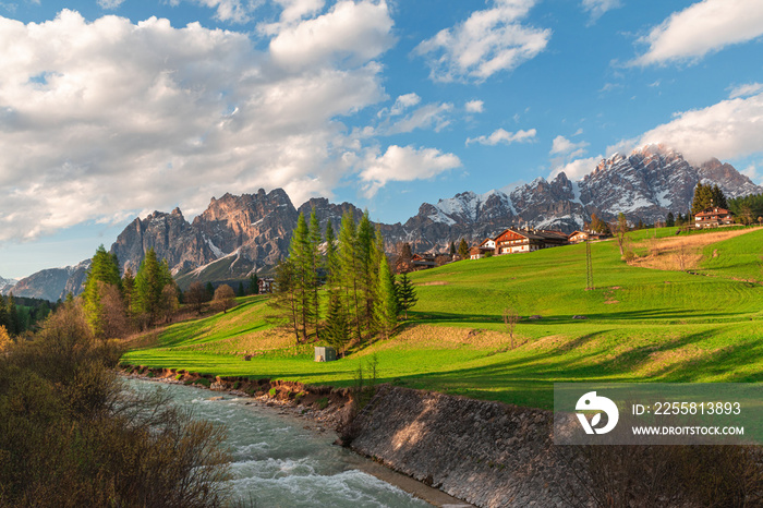 Beautiful alpine landscape of Italian dolomiti with river and green meadow. Cortina dAmpezzo town, Veneto, Italy