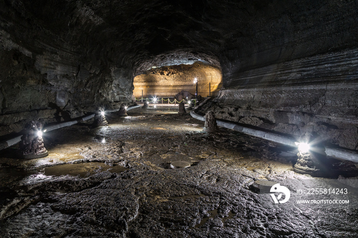 Dark, lit and empty Manjanggul Lava Tube Cave on Jeju Island in South Korea.